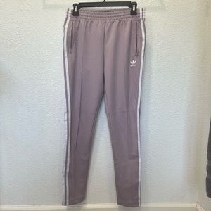 Purple Adidas track suit joggers with zippered pockets